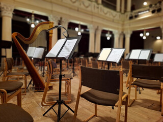 Music score with notes in hall of the conservatory at classical music concert
