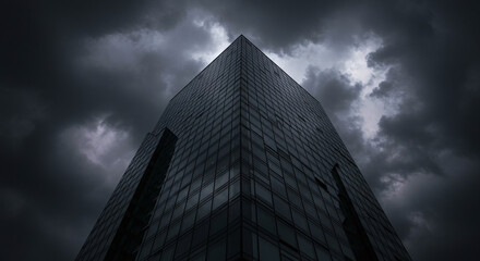 Imposing modern skyscraper silhouetted against a dramatic stormy sky