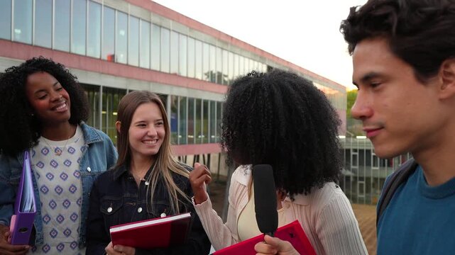 University students interviewing classmate on campus