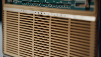 Classic radio box standing table playing music closeup. Macro view man hand