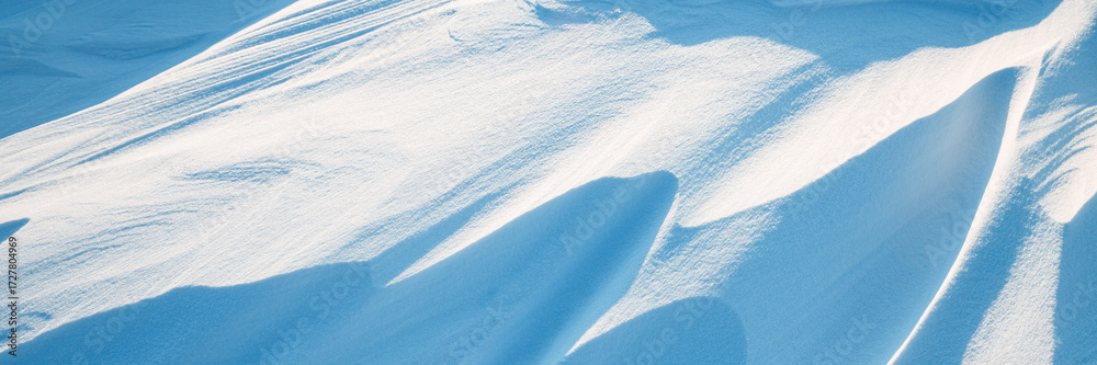 Wall mural snow texture. wind sculpted patterns on snow surface. wind in the tundra and in the mountains on the