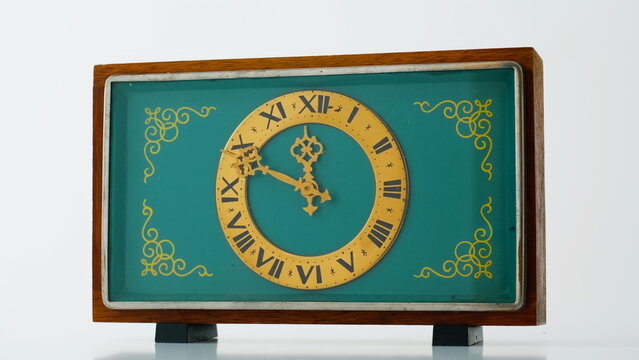 Vintage desk clock standing at surface closeup. Exquisite retro gadget showing 