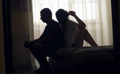 A couple sits together in silence, emotionally distant and disconnected. Despite physical closeness, tension and isolation dominate. A visual concept of relationship crisis and mental health.