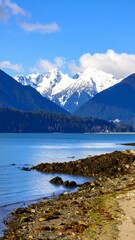 Snowy mountains over a tranquil fjord