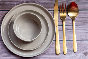 Empty plates, knife and fork over wooden table background. View from top with copy space.lose weight illustrated with an empty plate.