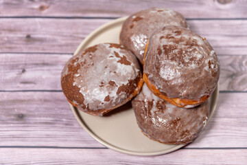 Donuts.Marmalade packets on a plate on a wooden background, donuts with marmalade