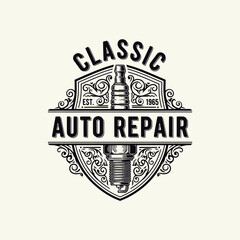 Obraz premium Vintage-style logo for a classic auto repair shop featuring a spark plug and ornate details on a shield.