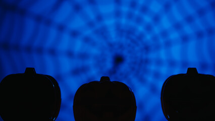 Blue Background with Halloween Spider Web and Pumpkin Silhouettes