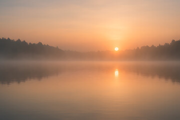 Fototapeta premium Tranquil Sunrise Over Misty Lake