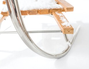 Close-up of a wooden and metal sled with snow