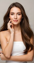 Fototapeta premium Professional Studio Portrait of a Young Woman with Long Brown Hair and a Gentle Smile, showcasing her Natural Beauty and Smooth Skin
