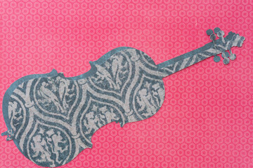 cut paper musical instrument silhouettes on bold coral pink paper