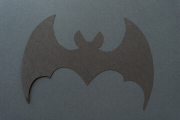 isolated black paper bat on a dark black surface