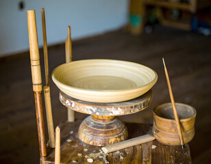 Artisan pottery wheel with clay bowl ready for crafting process
