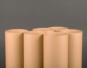 Rolled paper tubes arranged on a gray background for creative projects