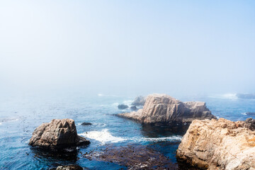 Pacific Coast of Big Sur, California with fog over ocean