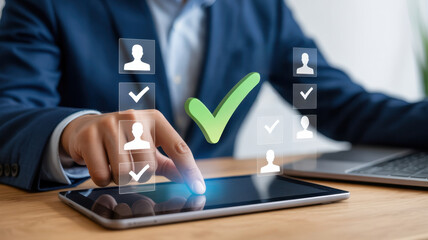 A businessman is using a tablet to select the best candidate for a job, with a green check mark indicating the selected candidate