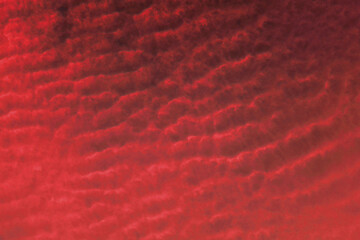 Red background and cloudy sky. Textured background. Dark and danger. Red sky and smoke. Textured design for paper or fabric. 