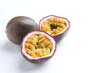 Fresh passion fruits on white background, closeup. Space for text
