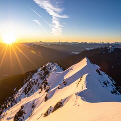 A vibrant sunset casts golden rays over a snow-covered mountain range, illuminating the peaks and valleys in a breathtaking panorama