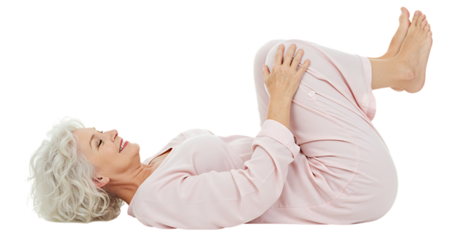 Smiling senior woman in pajamas lying down, knees to chest