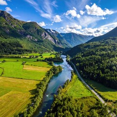 Aerial view of a serene river valley nestled between lush green mountains under a vibrant blue sky with fluffy white clouds