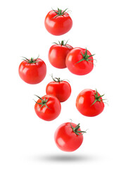 Fresh ripe tomatoes falling against white background