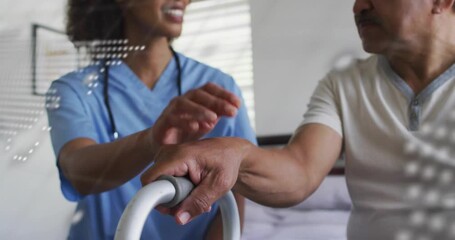Senior patient gripping walker while nurse guiding step for health, digital map and code fading - Powered by Adobe