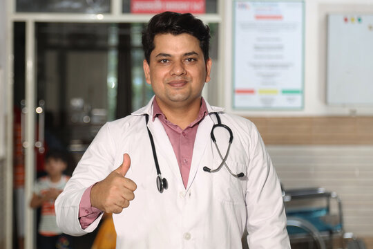Portrait of doctor showing thumb up while standing in hospital. male doctor wearing uniform and stethoscope. Concept Healthcare