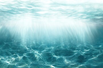 Bright sunlight rays penetrating through clear water illuminating the calm ocean floor underwater environment