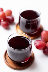 Red grape juice in glass and fresh grapes fruit on white background, Healthy drink