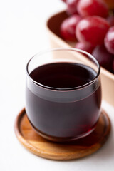 Red grape juice in glass and fresh grapes fruit on white background, Healthy drink