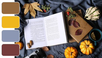 Books with autumn leaves, pumpkins and cup of tea on cozy plaid