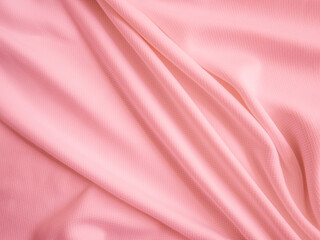 Pink crumpled  fabric background. Wavy cloth texture