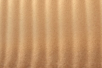 Close-up view of fine brown sand with evenly spaced ripples creating a textured pattern