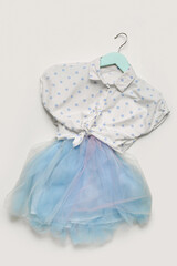Hanger with stylish children's clothes on grey background