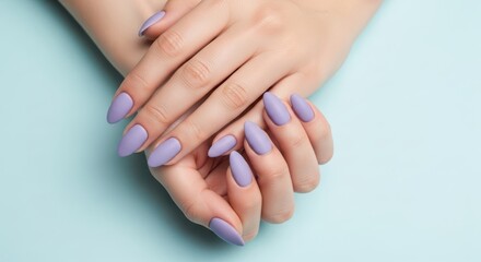 Fototapeta premium Closeup of a womans hands with perfectly manicured almondshaped nails painted in a soft lavender color