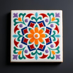 Photorealistic close-up of a ceramic tile with symmetric mandala design in vibrant orange, blue, red-purple, and green floral/scroll patterns and central orange flower