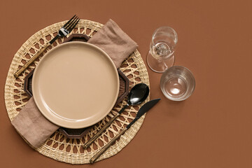 Beautiful table setting on brown background