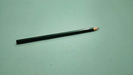 Pencil isolated on green background 