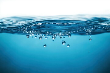 Close-up of clear blue water surface with rising bubbles creating a dynamic and refreshing underwater scene
