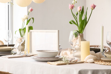 Elegant table setting with beautiful tulip flowers in restaurant