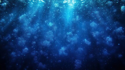 Underwater scene with sun rays piercing through deep blue water filled with rising air bubbles creating a serene and mysterious atmosphere