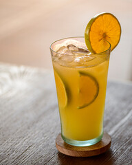 Fresh Orange Juice with Ice and Citrus Slices in Glass