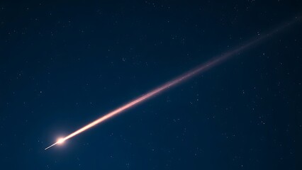 Fototapeta premium A brilliant meteor streak with a glowing tail in a star-filled night sky.