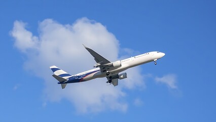 Obraz premium Commercial airliner ascending through clouds against blue sky, aviation.