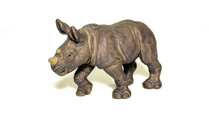 Obraz premium Realistic toy rhinoceros figurine isolated on white background