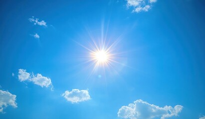 Bright sun shining in a clear blue sky with a few scattered white clouds on a sunny day