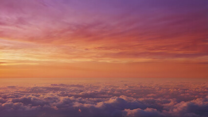 Purple and Orange Sunset Sky with Fluffy Clouds - Aerial View