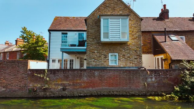Great Stour riverside architecture in Canterbury, Kent, England, UK, with brick facades, timber fronts and water reflections